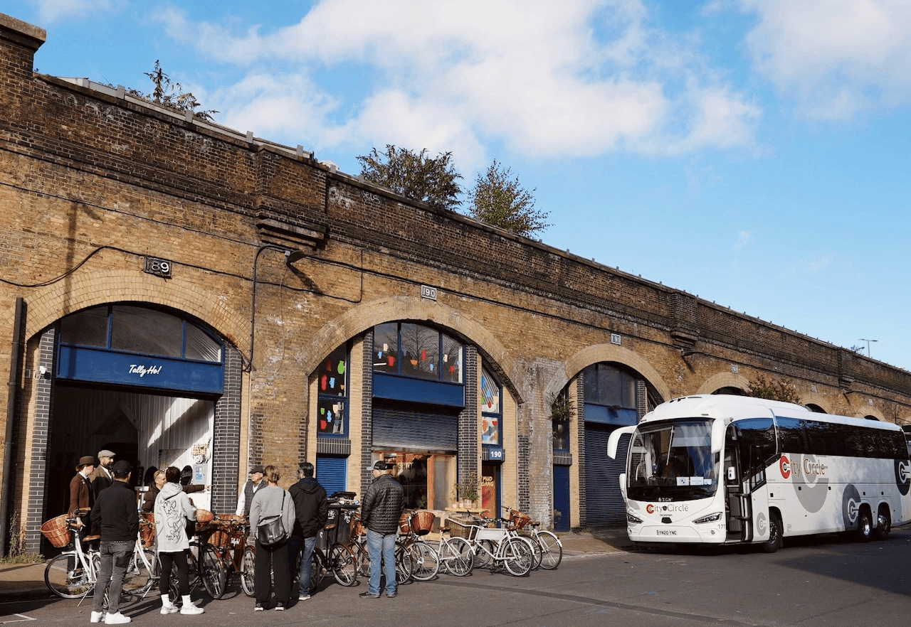 Private group setup outside Tally Ho HQ — seamless logistics, bikes prepped, coach waiting.