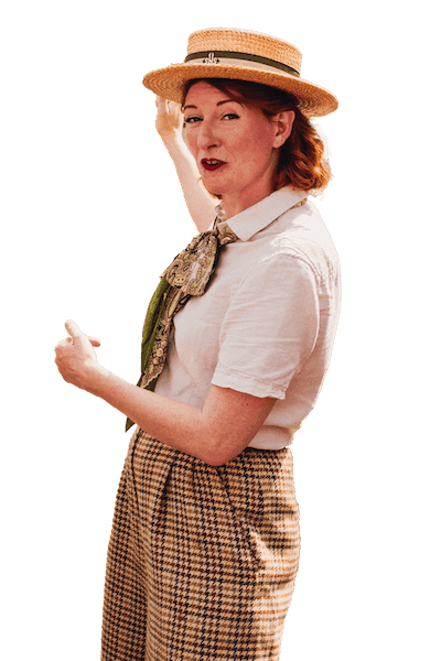 A Tally Ho London tour guide dressed in vintage British clothing 