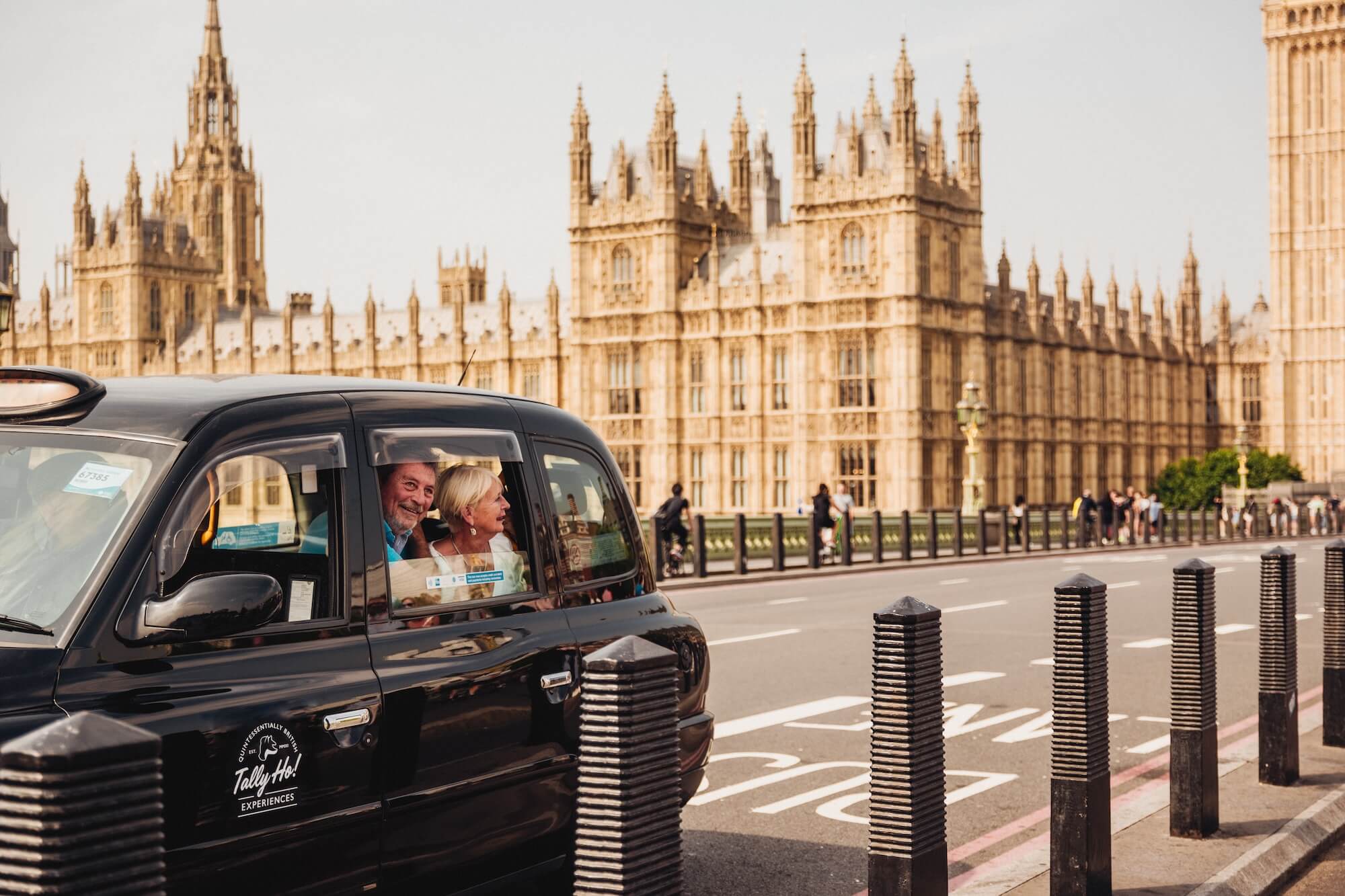 A couple look out the window of a London taxi at Westminster Bridge and Big Ben 