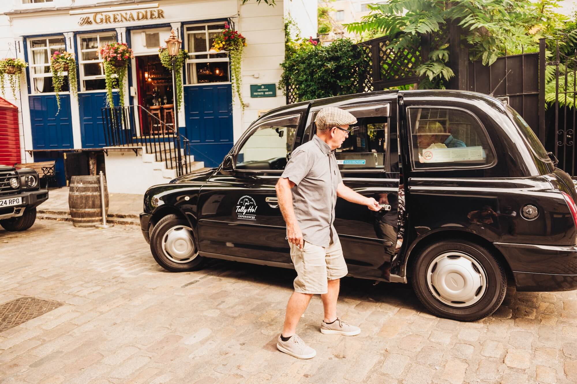 A London taxi tour stopped outside the Grenadier pub 