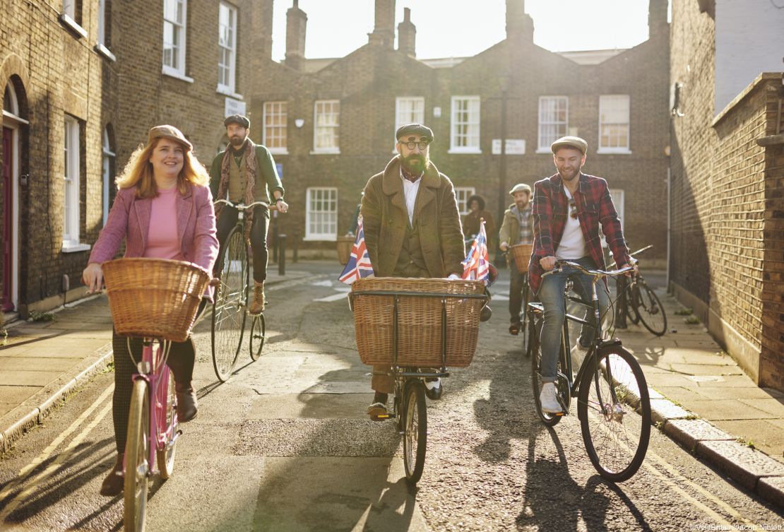 A group of cyclists on vintage bicycles riding through London on a bike tour 
