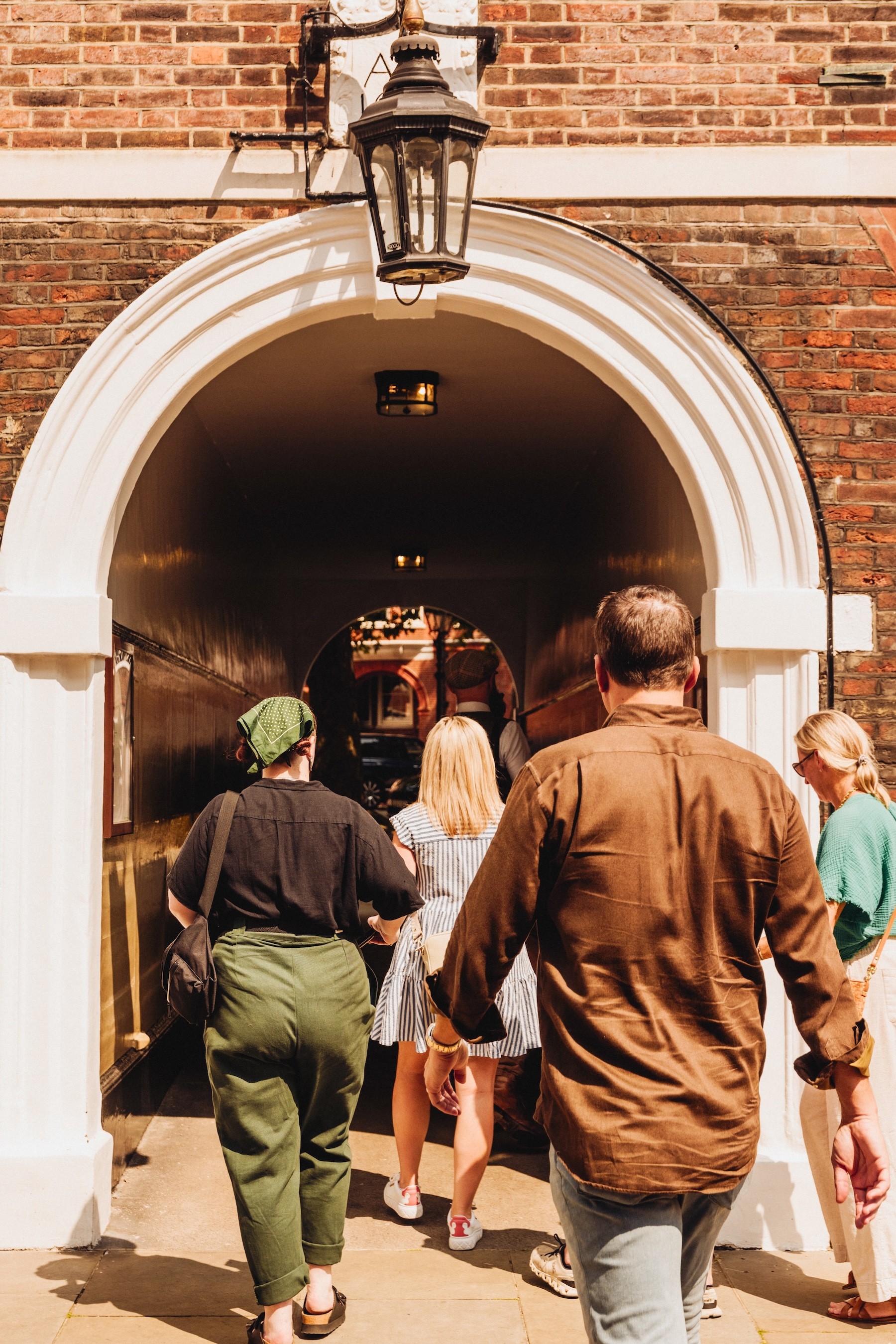 People walk through a tunnel on the secret London pub tour 