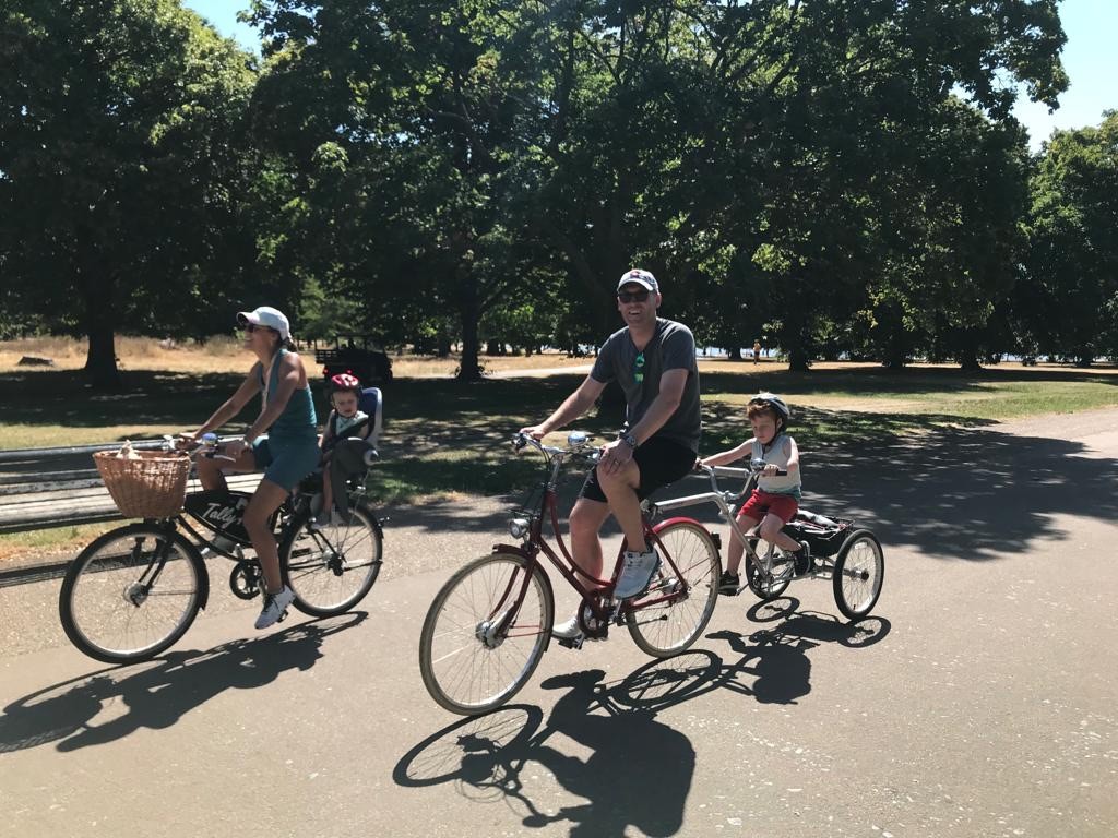 A tourist family cycling through Hyde Park in London 