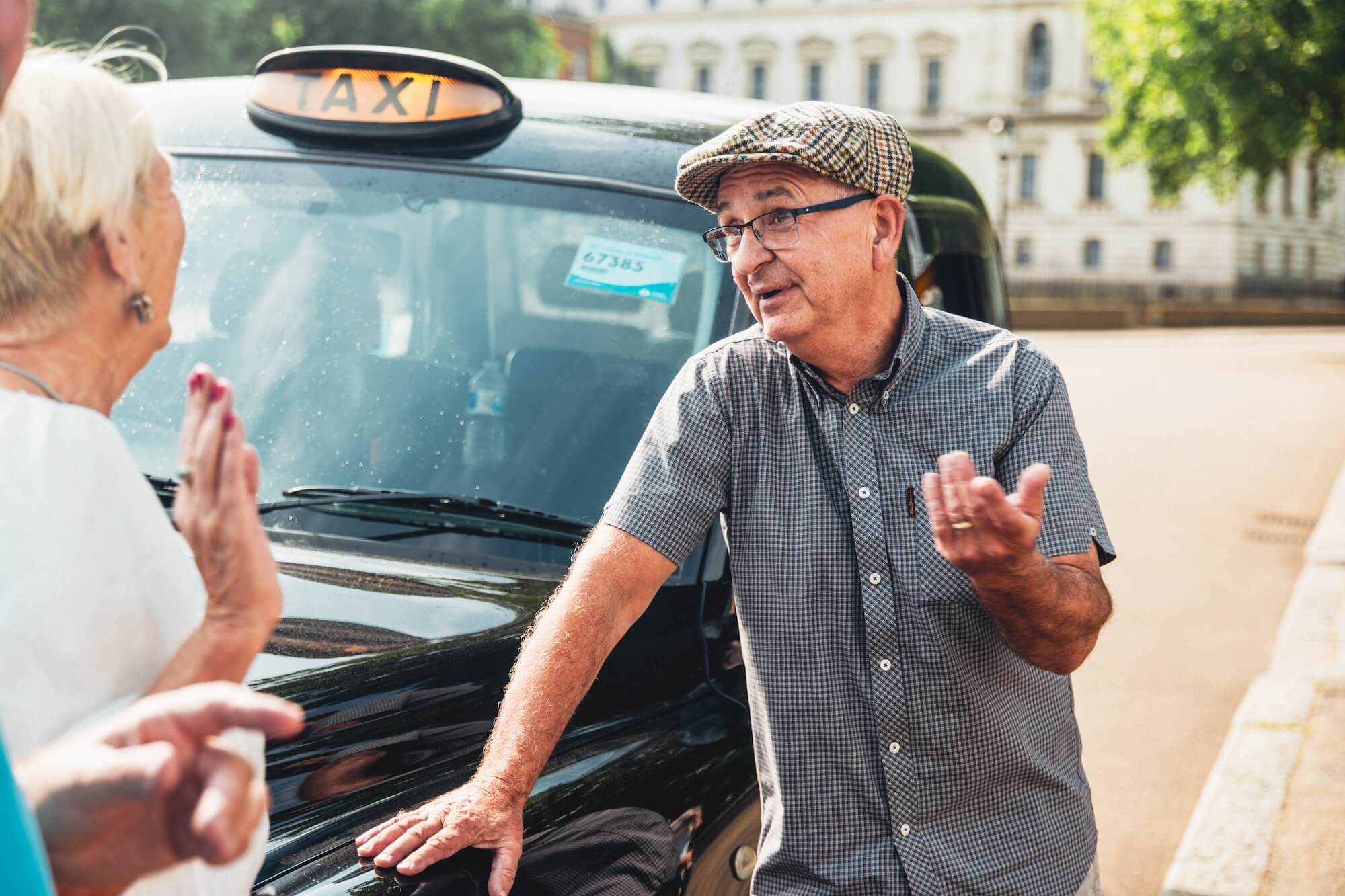 A Tally Ho London taxi tour guide engaging with guests 