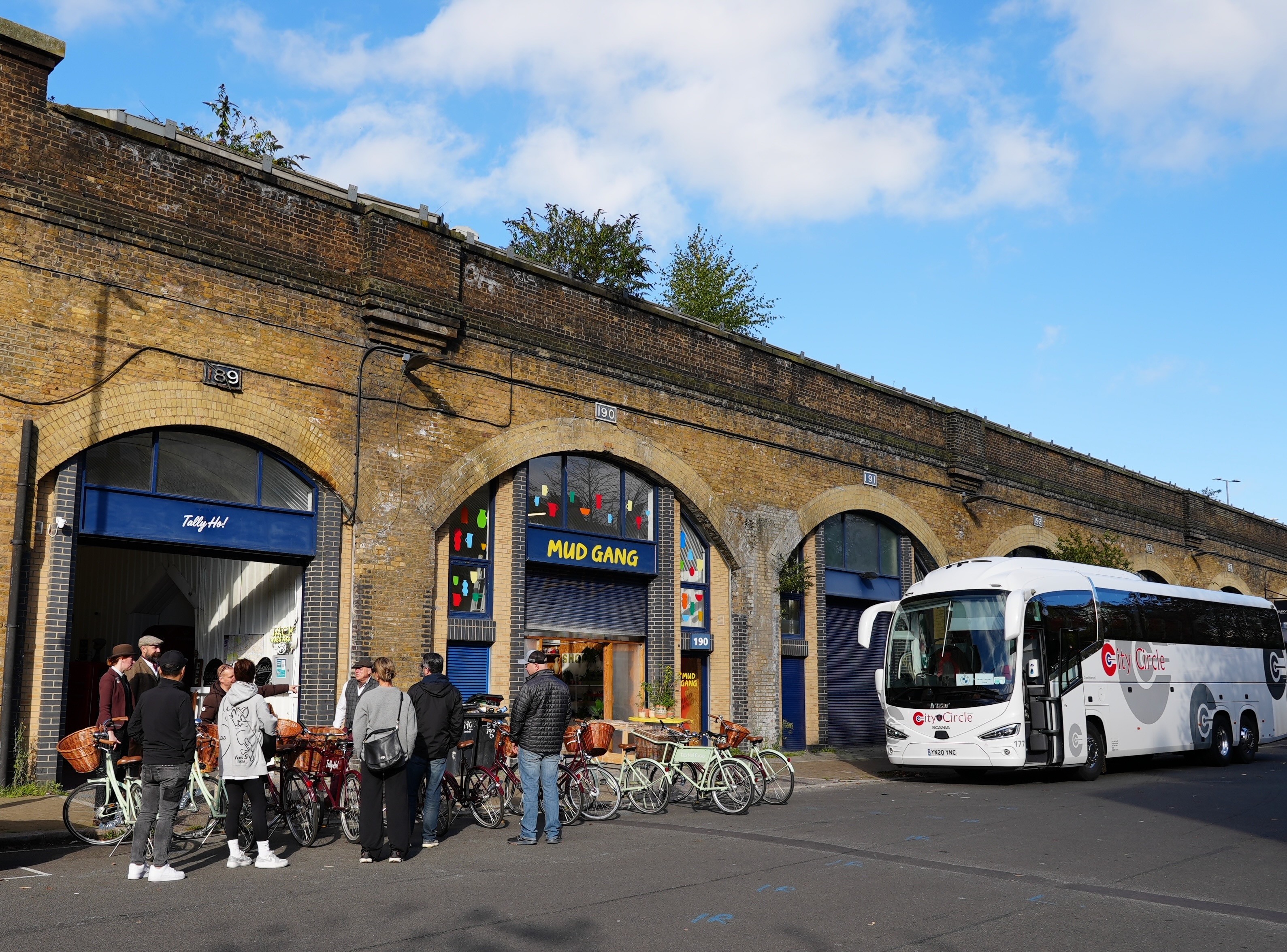 A coach drops off a corporate group at Tally Ho HQ for a London bike tour
